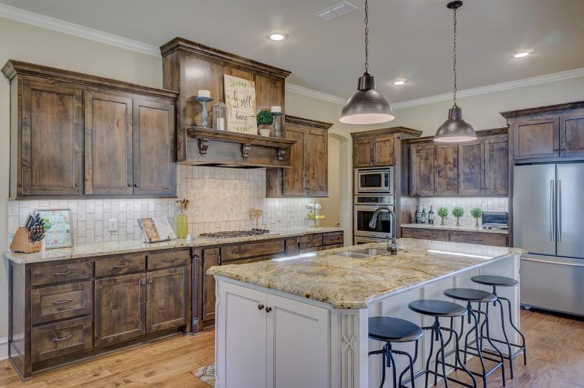 Stainless steel kitchen appliances paired with rustic, distressed cabinetry